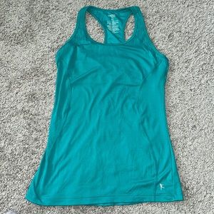 Danskin fitted racerback workout top. Teal size small (4-6). Built in bra.